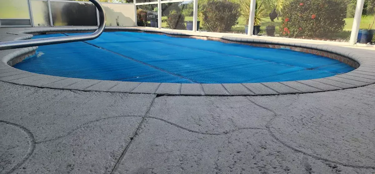 Cracked concrete pool deck in Central Florida before resurfacing