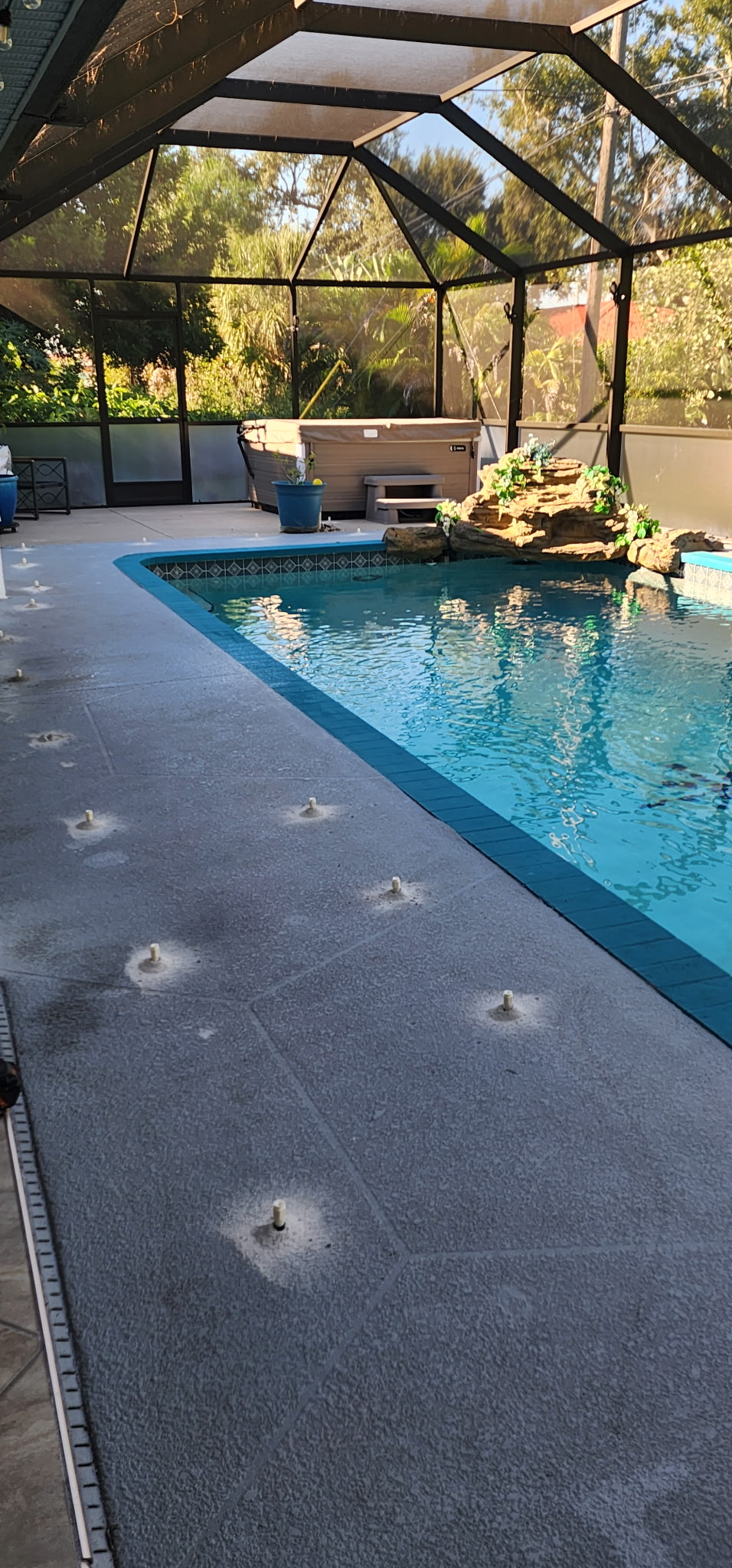Actual EFS pool deck with injection ports positioned across the concrete slab before patching
