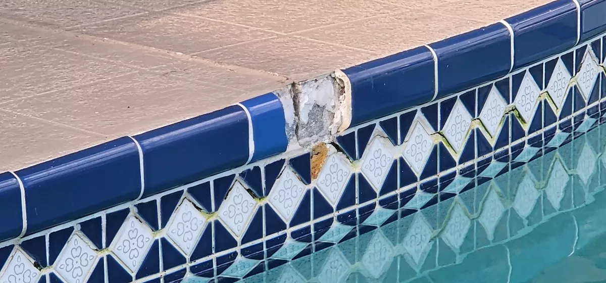 Cracked and separating pool coping and tile caused by concrete movement